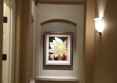 A hallway with a painting on the wall.