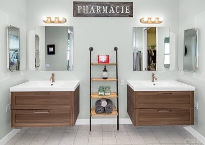 A bathroom with two sinks and a mirror.